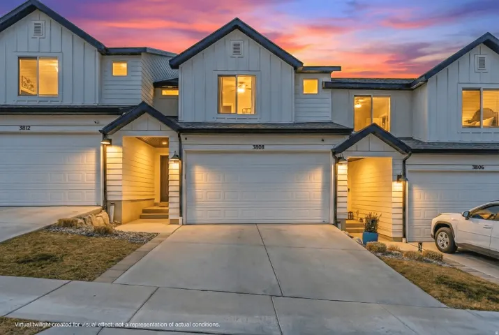 Modern townhome exterior featuring clean lines and contrasting dark trim