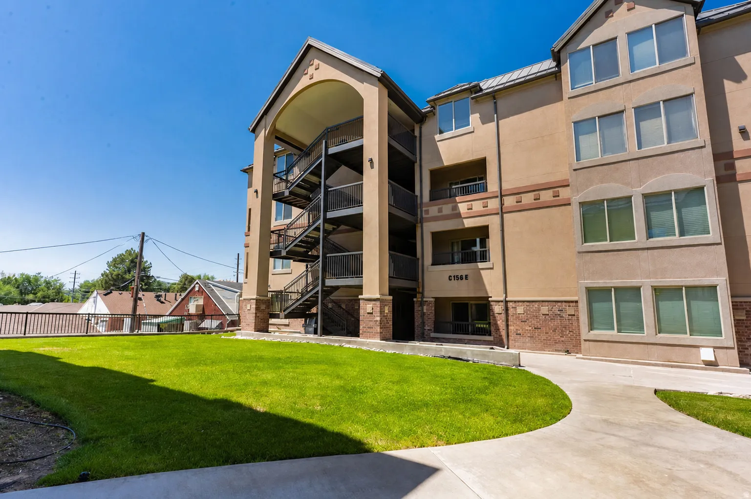 Multi-story building featuring a stucco exterior with stone accents and multiple large windows