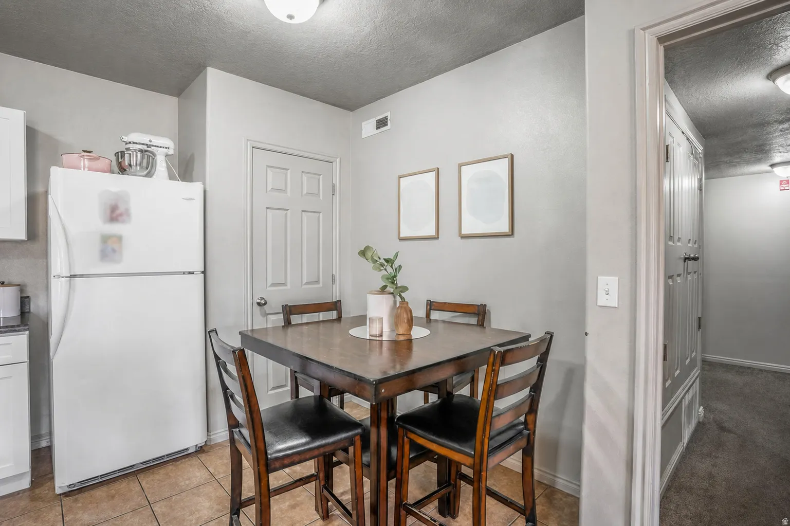 Dedicated dining area featuring neutral wall tones and tile flooring
