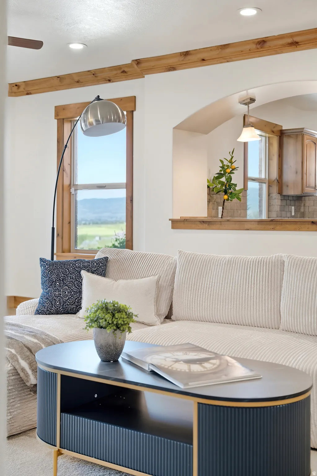 Living area featuring exposed wood beams, recessed lighting, and wood-framed windows