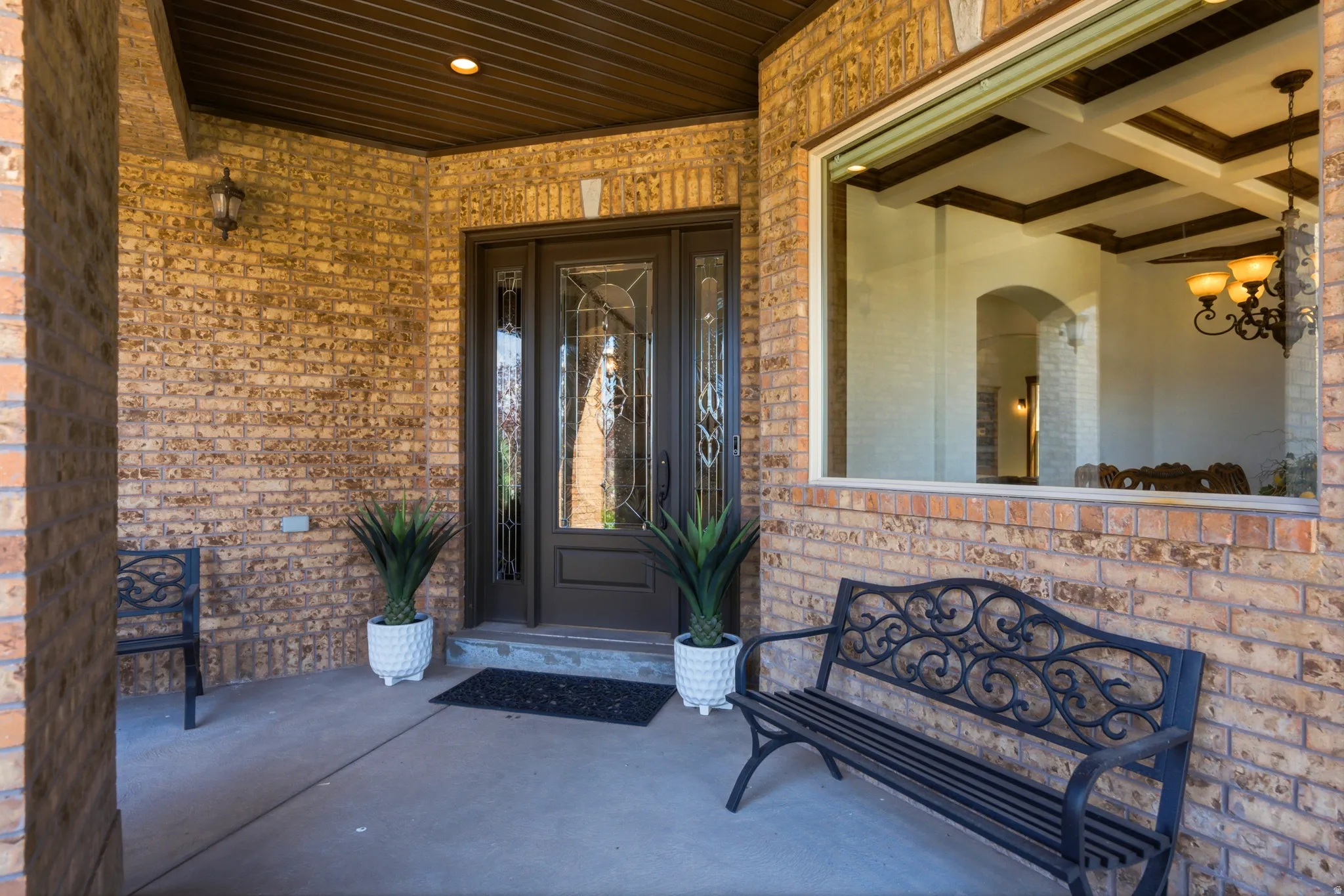 Brick exterior with a covered entryway and a prominent window