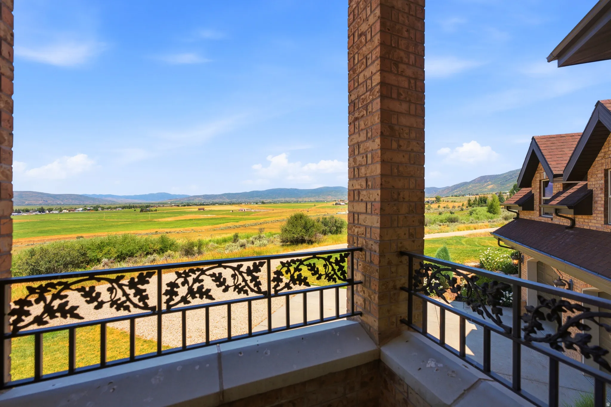 Balcony overlooking expansive green landscapes and distant mountains