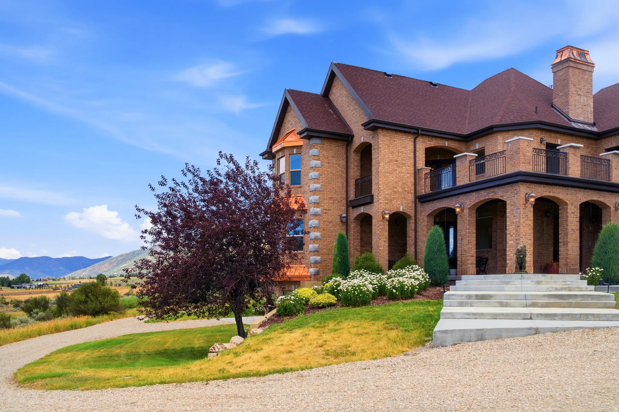 Brick exterior featuring multiple arched entryways and a covered patio