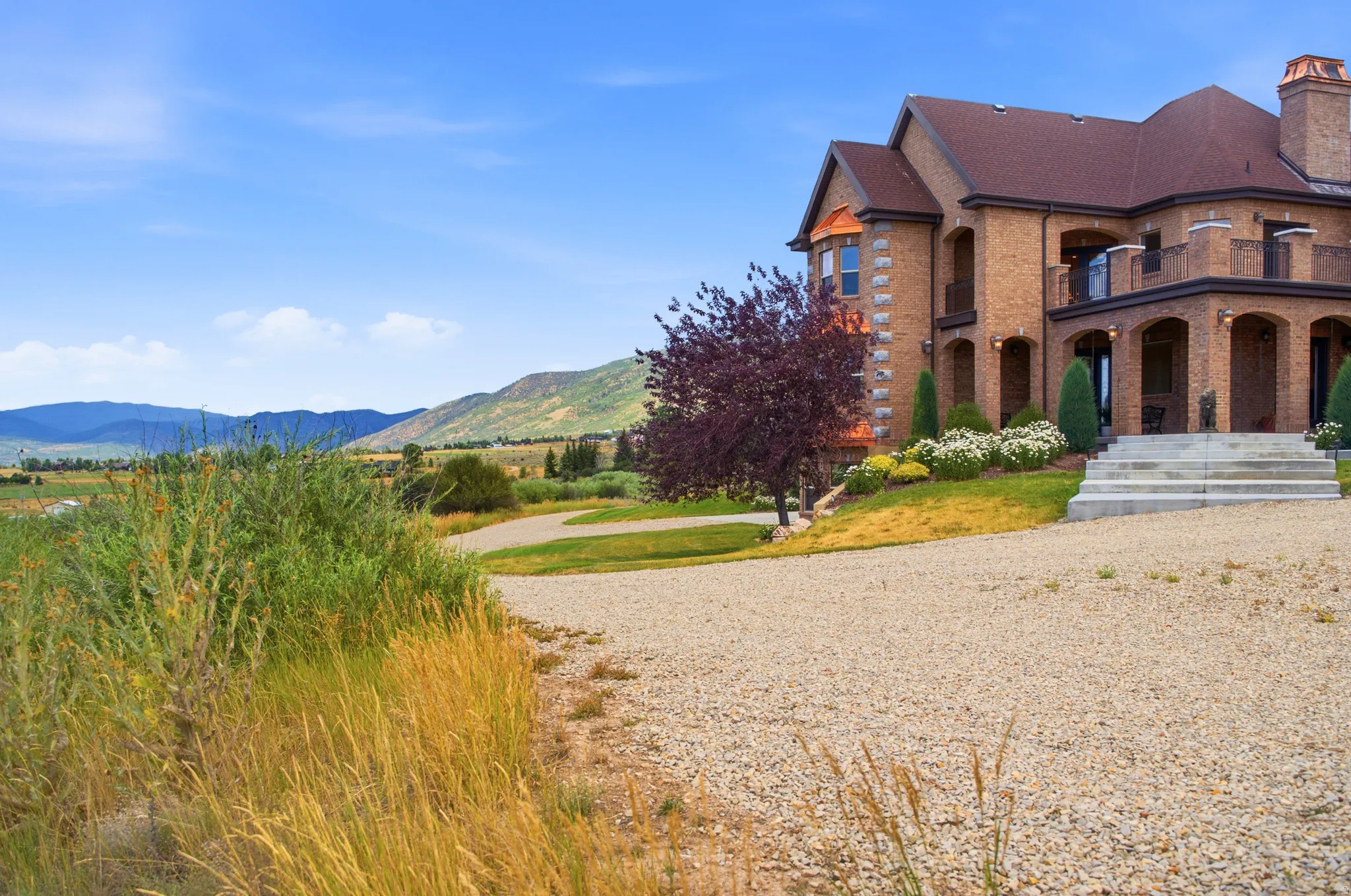 Distinguished brick exterior with a multi-level design and arched entryways