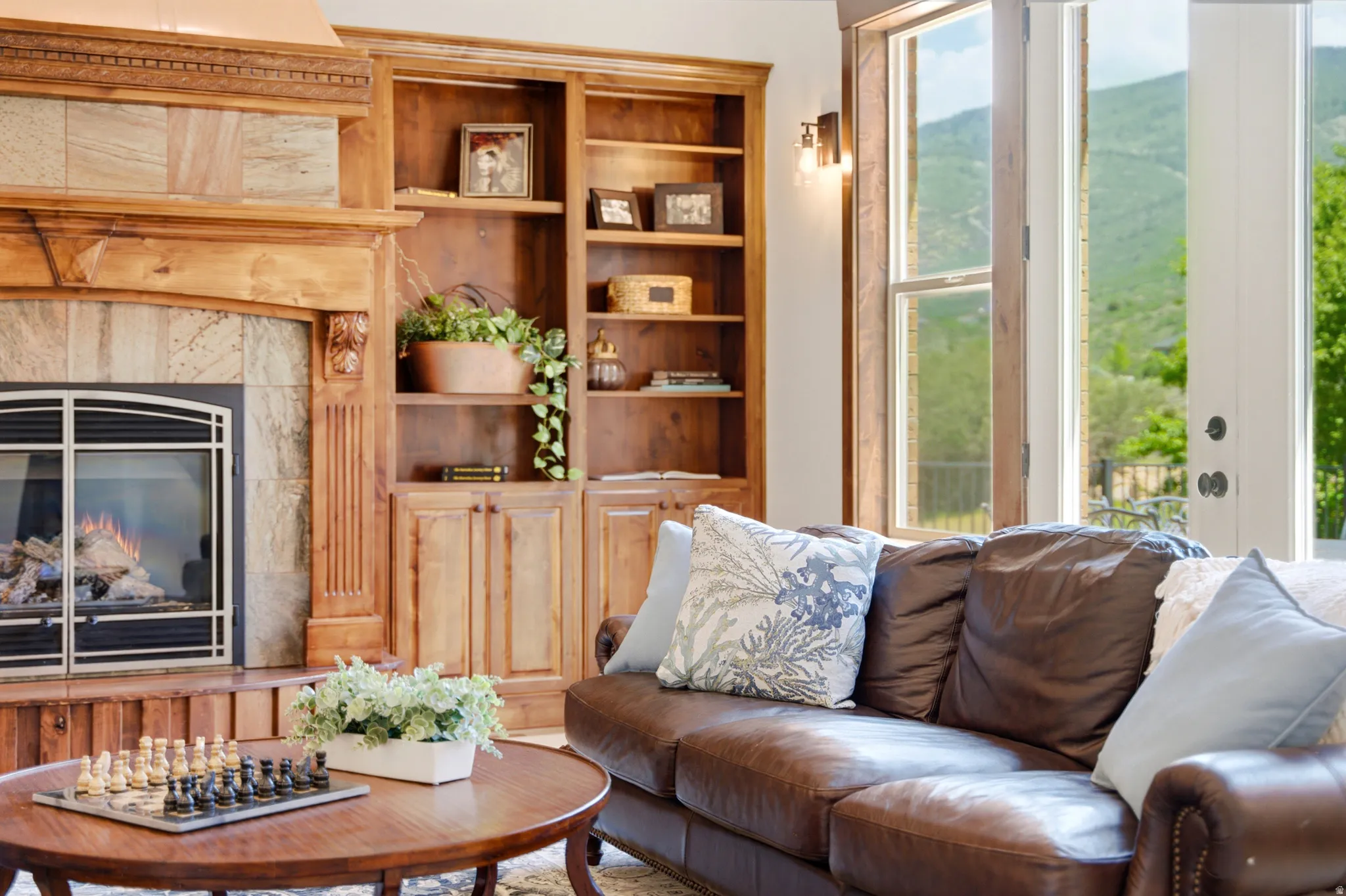 Fireplace featuring a stone tile surround and wood mantel