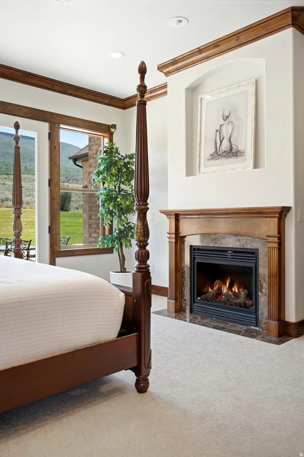 Bedroom featuring a built-in fireplace with a stone surround and wood mantle