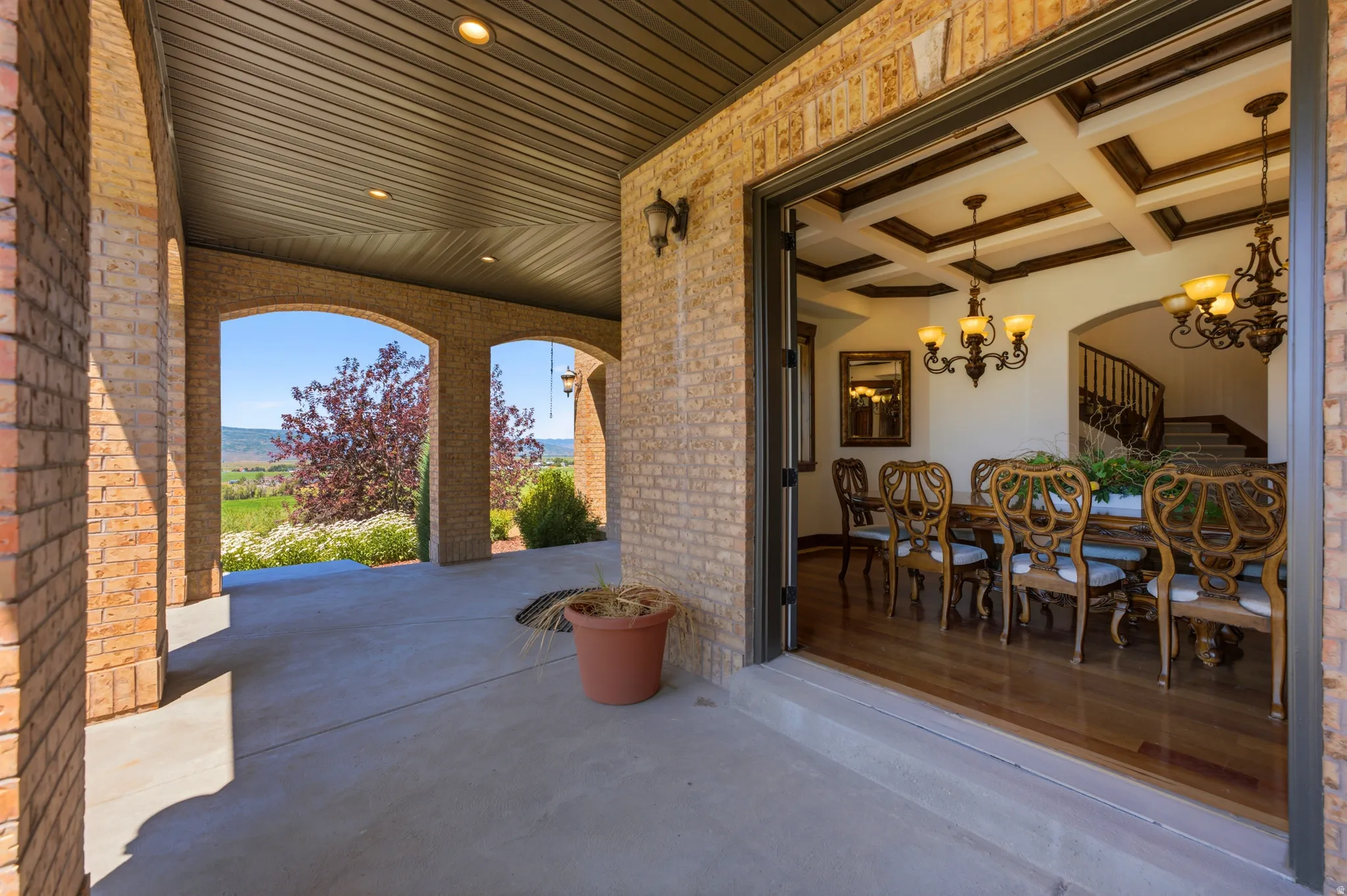 Brick archway patio with a coffered ceiling