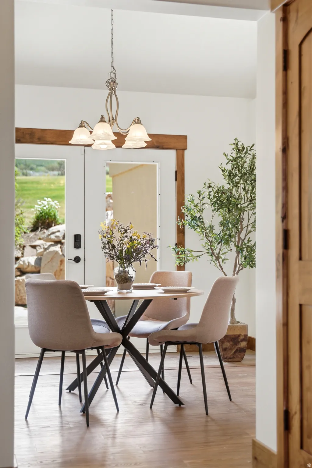 Light wood-finish flooring with white walls and natural wood trim