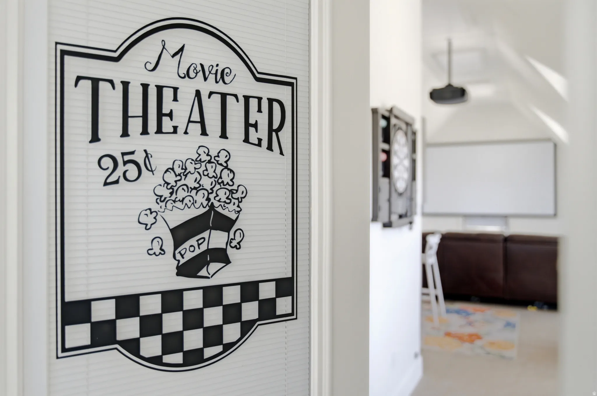 Dedicated media room featuring a large projector screen and high ceilings