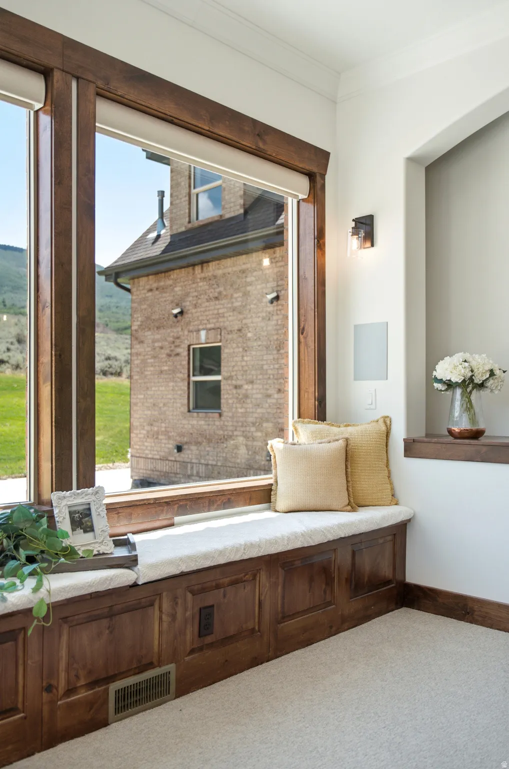 Built-in window bench featuring rich wood paneling and a cushioned seat