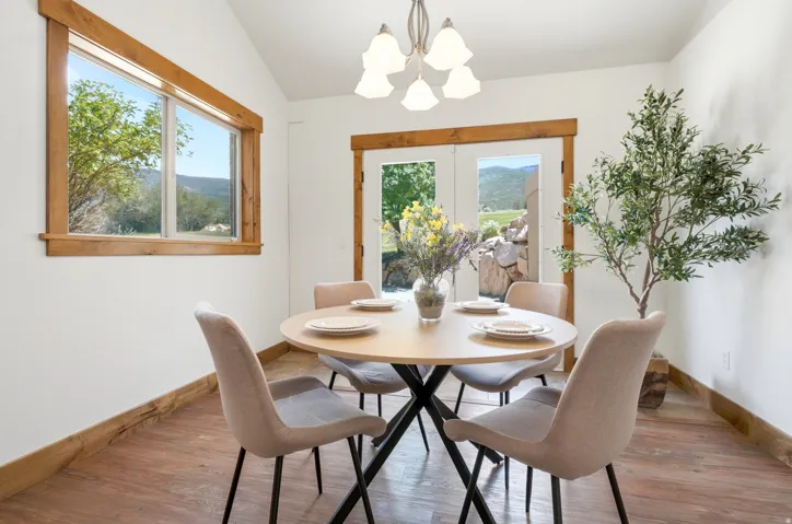 Dining space featuring wood-finish flooring and white walls