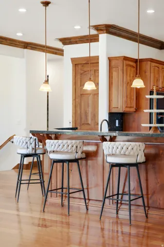 Kitchen island with a dark countertop and rich wood-finish cabinetry