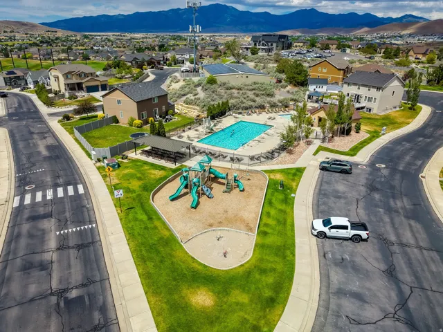 Community amenities featuring a playground, swimming pool, and covered seating area
