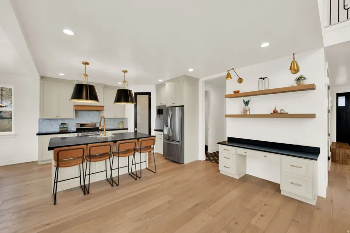 Spacious open-concept living area featuring wide plank wood-finish flooring