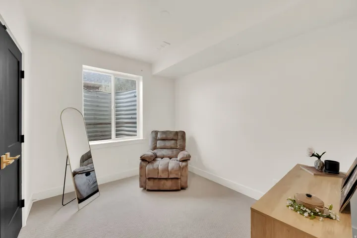 Bright room featuring a single window, recessed lighting, white walls, light-colored carpeting, and white baseboards