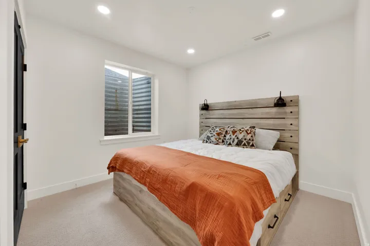 Light-filled room featuring recessed lighting, a window with white trim, and light-colored carpeting