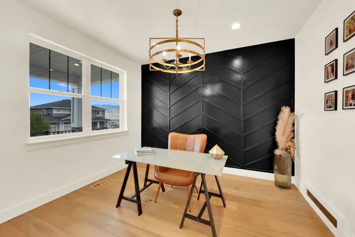 Defined interior space featuring a striking black accent wall with a chevron pattern