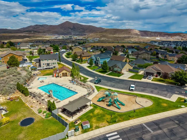Community amenities featuring a swimming pool, shaded picnic area, and playground