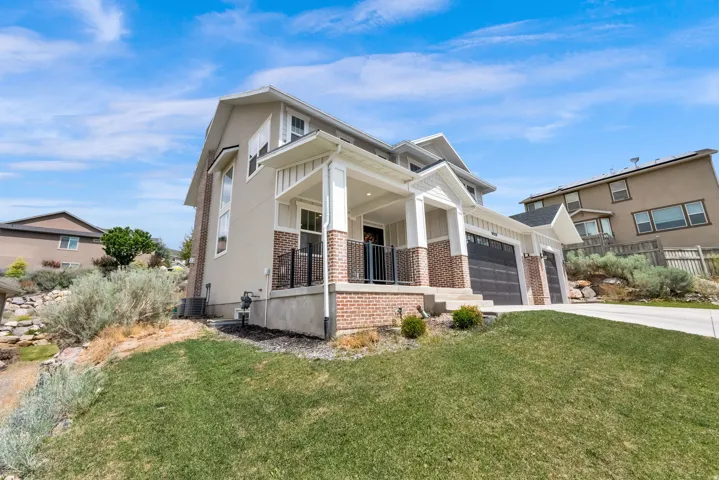 Contemporary residence featuring a two-story design with a covered porch
