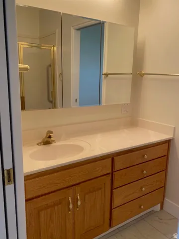 Light wood-finish vanity with integrated sink and countertop