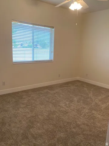 Carpeted flooring, window with blinds, ceiling fan with integrated lighting