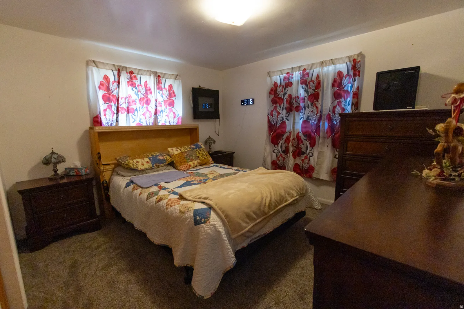 Neutral wall color with a window featuring decorative valances