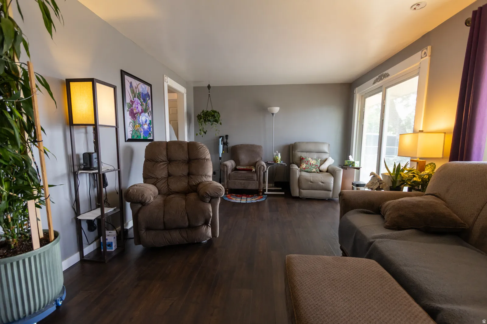 Living area featuring dark wood-finish flooring and light gray painted walls