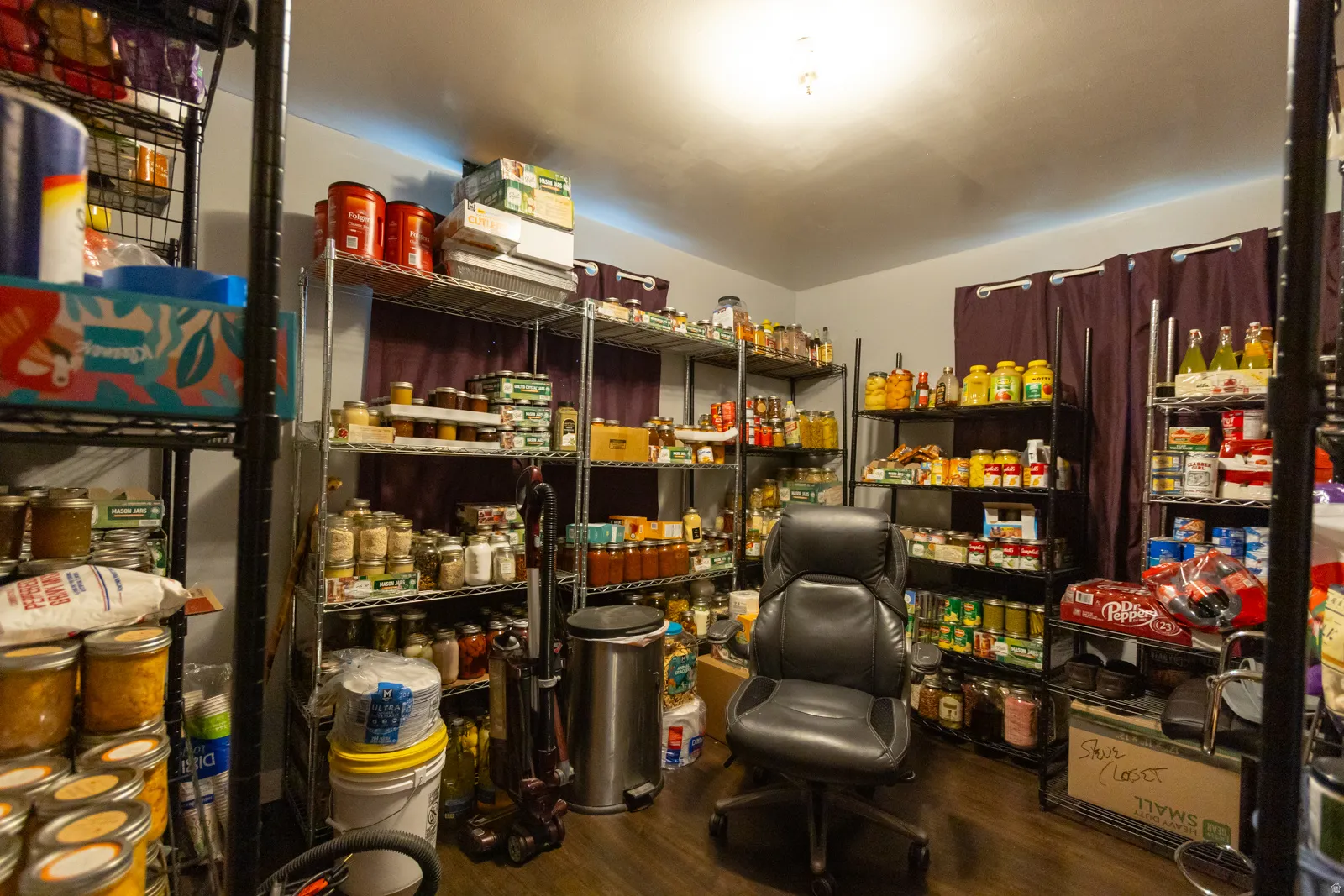 Dedicated storage room featuring multiple freestanding metal shelving units for organization