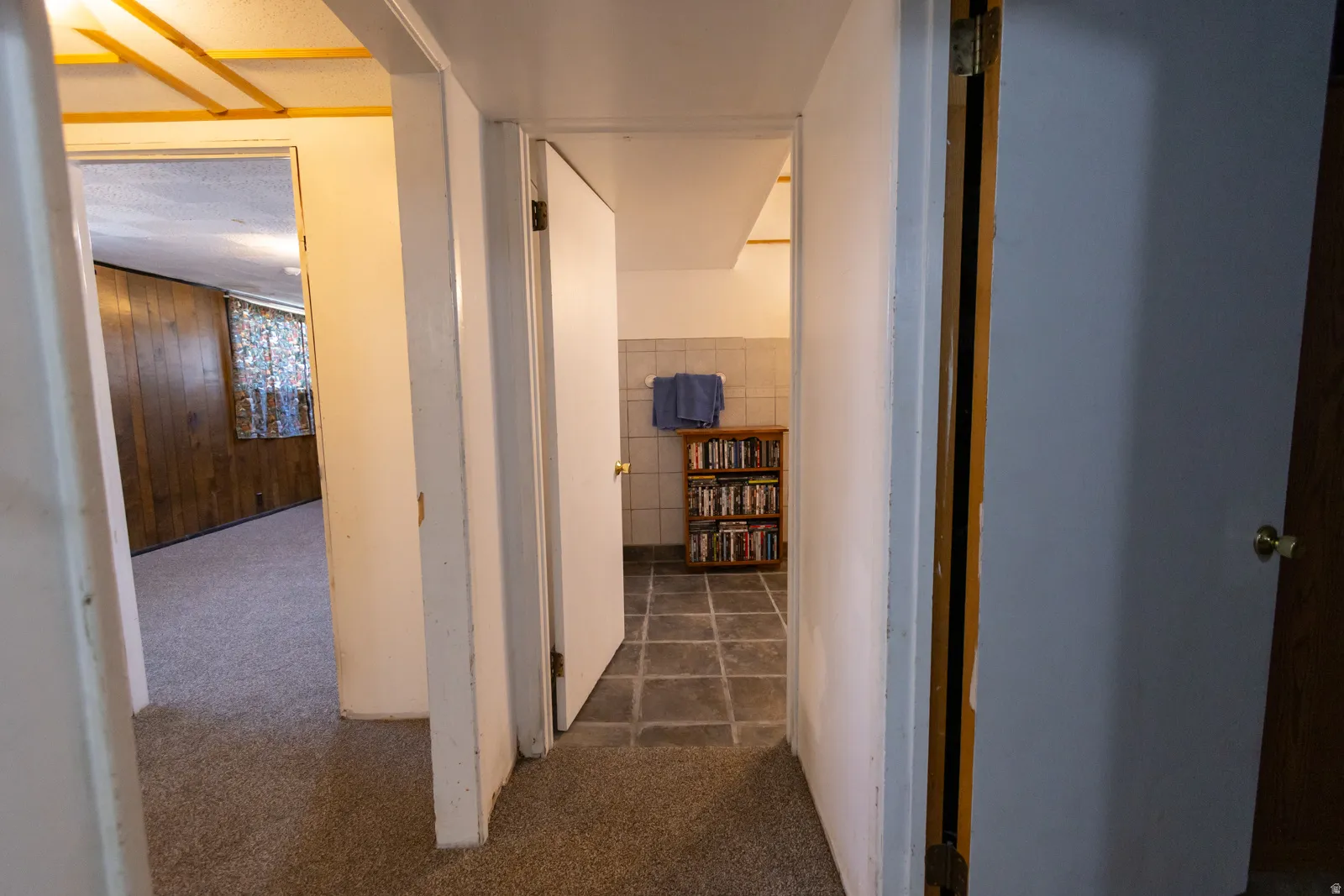 Hallway featuring carpet flooring and multiple doorways