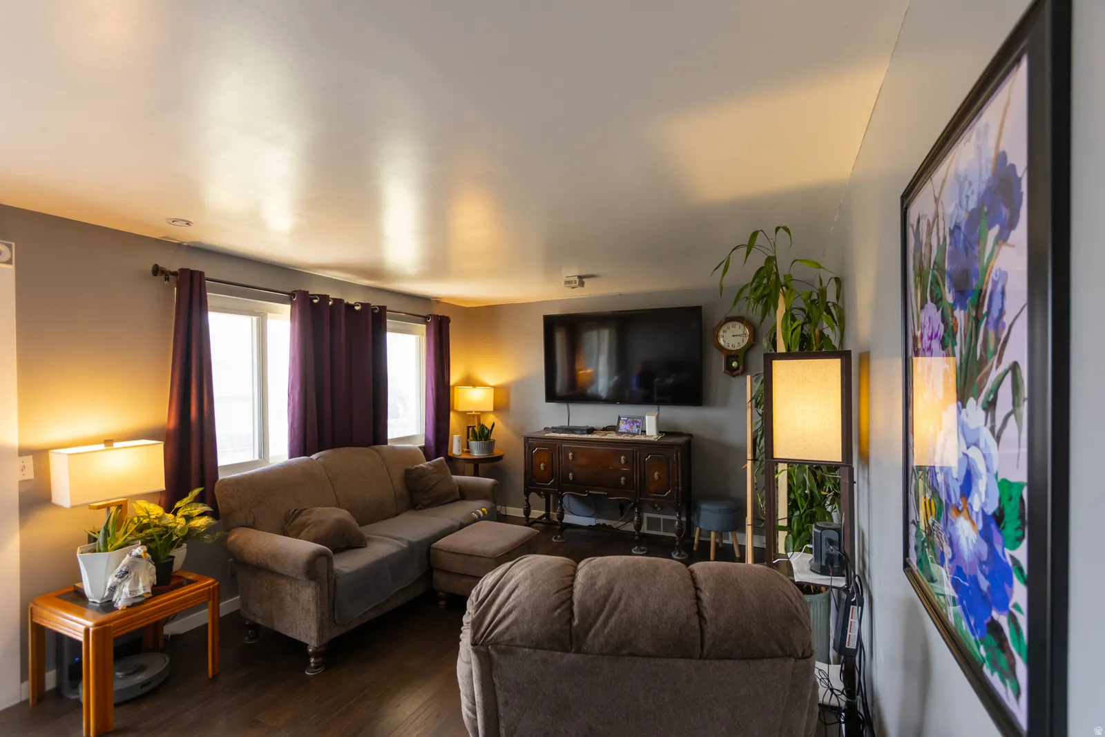 Living area featuring wood-finish flooring, recessed lighting, and dual windows