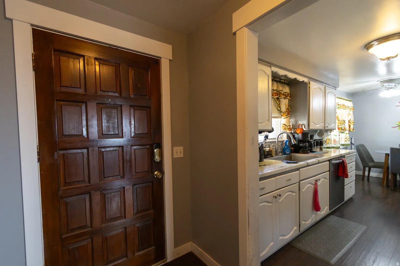 Rich wood-paneled entry door with white trim