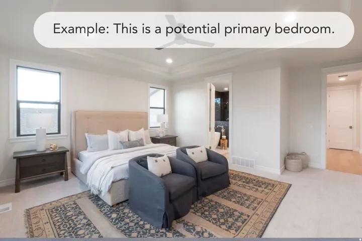 Spacious sleeping area featuring a tray ceiling with a ceiling fan, dual windows with black trim, and carpeted flooring