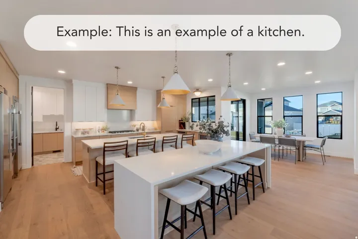 Spacious kitchen featuring a large central island with seating, light wood-finish flooring, white cabinetry, a built-in refrigerator, and multiple windows