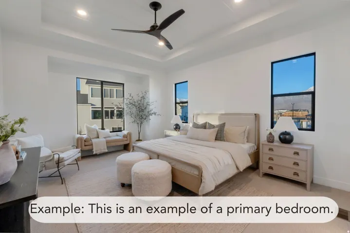 Spacious room featuring a tray ceiling with recessed lighting and a modern ceiling fan