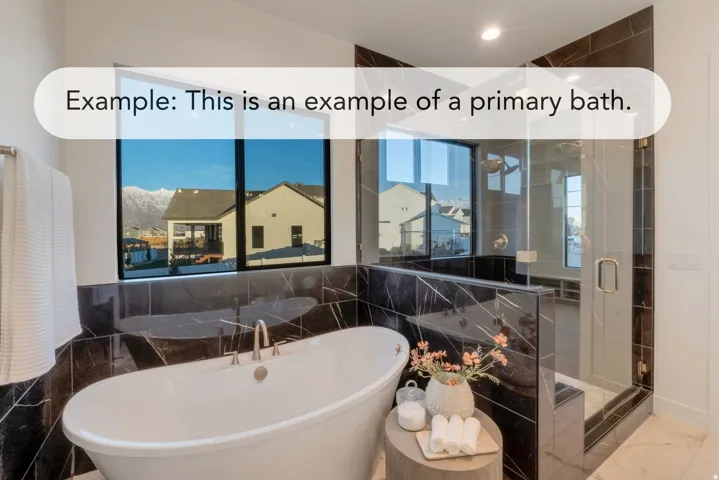 Freestanding soaking tub with brushed nickel fixtures, complemented by a glass-enclosed shower with dark tile surround and a tiled bench