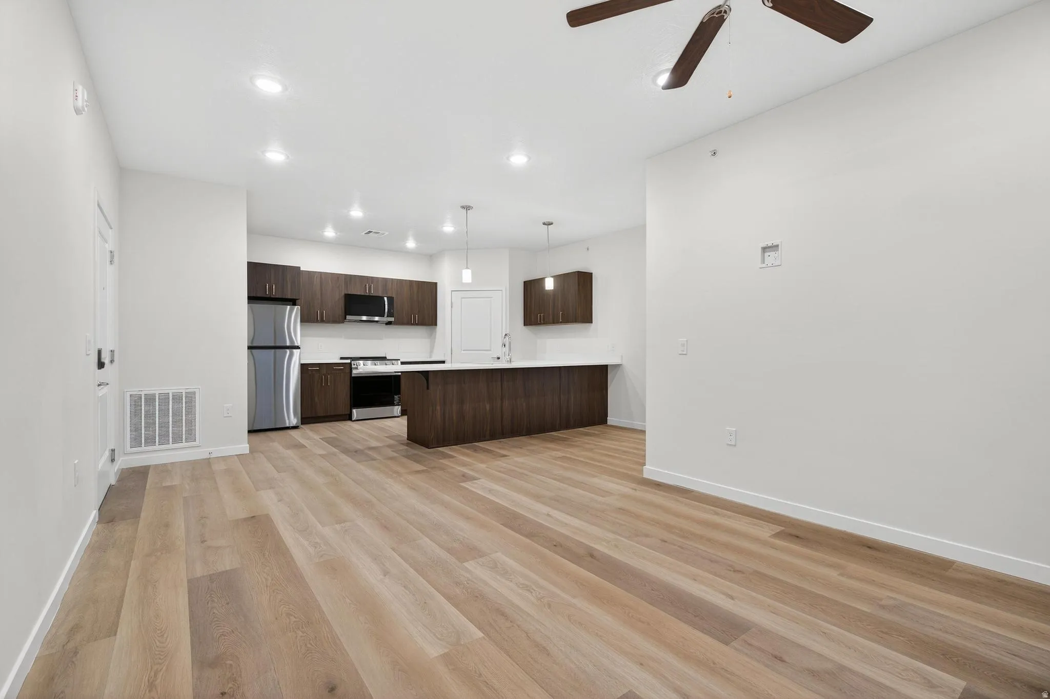 Open concept living space featuring light wood-finish flooring
