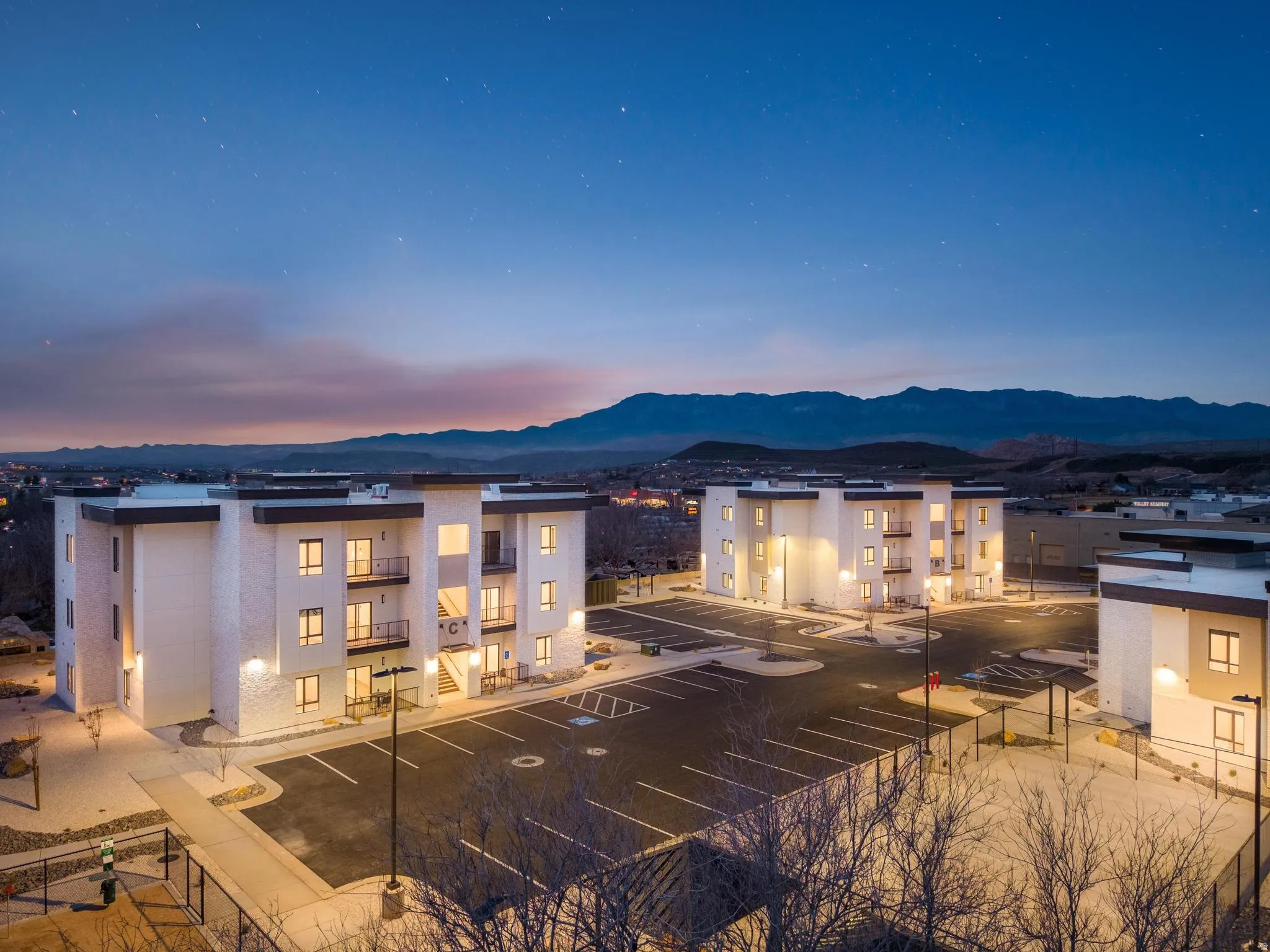 Modern building exteriors with balconies and ample parking