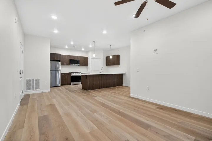 Open concept living space featuring light wood-finish flooring