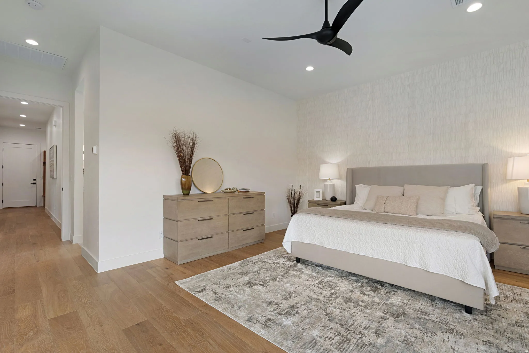 Spacious room featuring wide plank wood-finish flooring, recessed lighting, and a modern ceiling fan