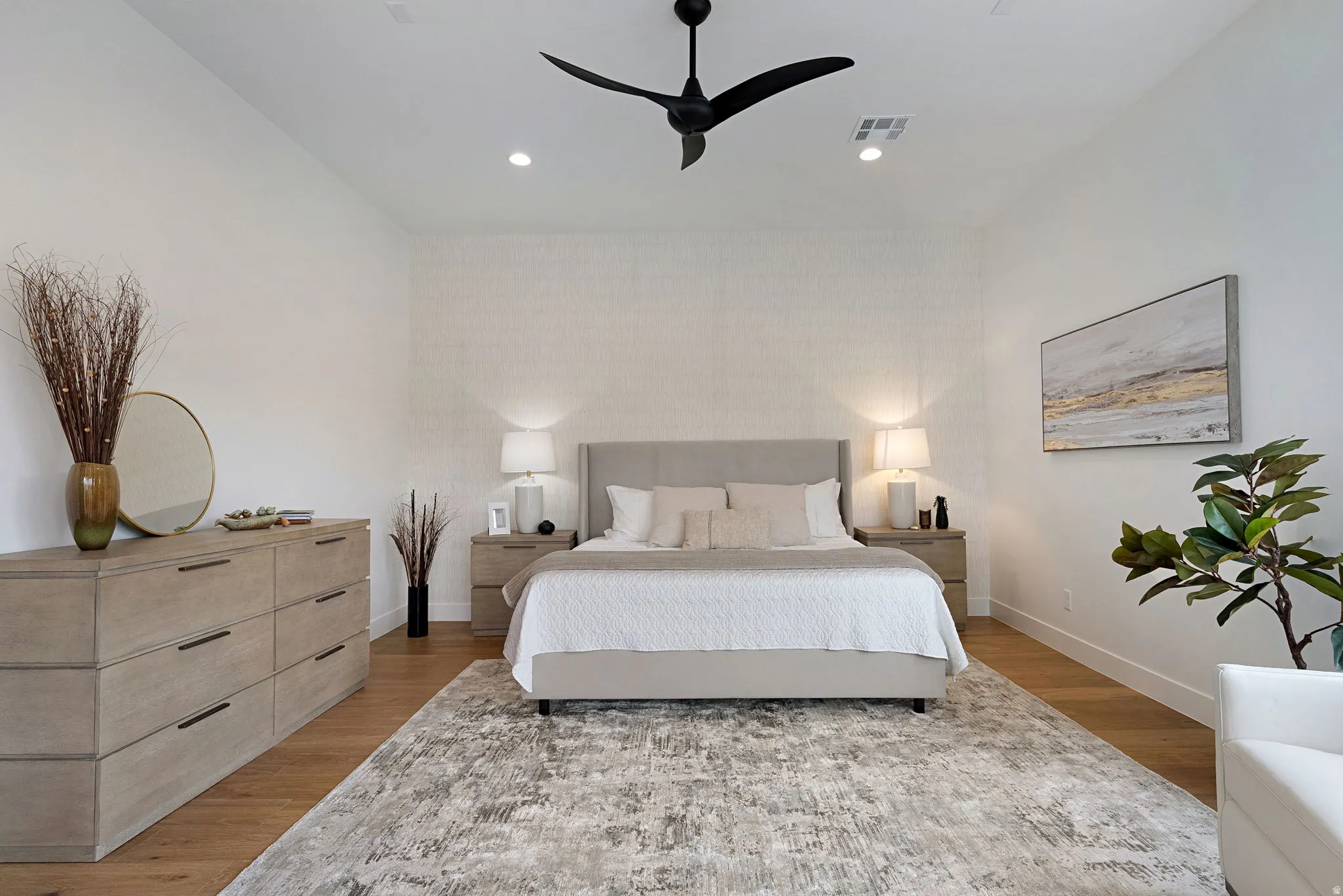 Spacious room featuring wood-finish flooring, recessed lighting, and a contemporary ceiling fan