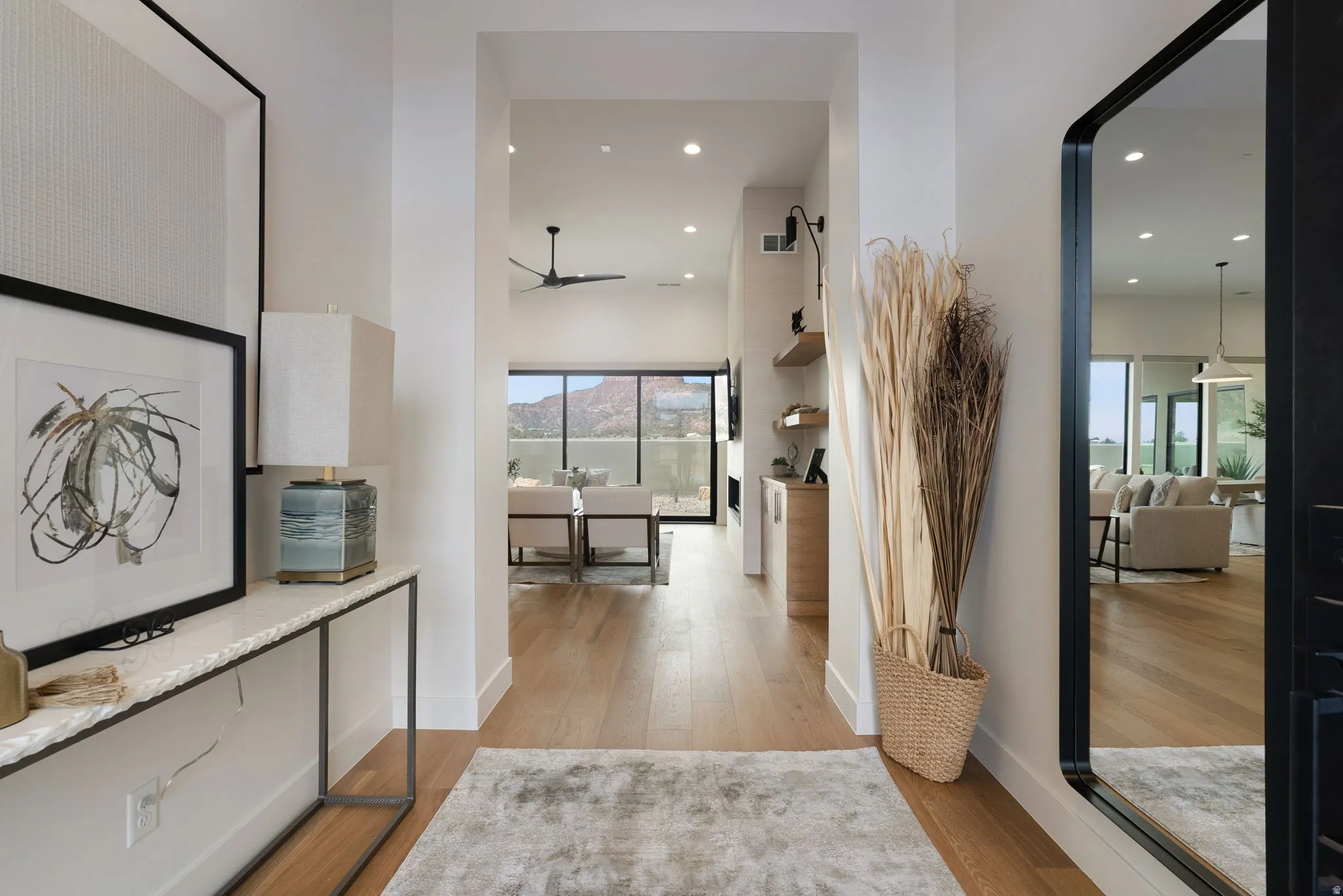 Hallway entry featuring wood-finish flooring, recessed lighting, and a console table with a textured top