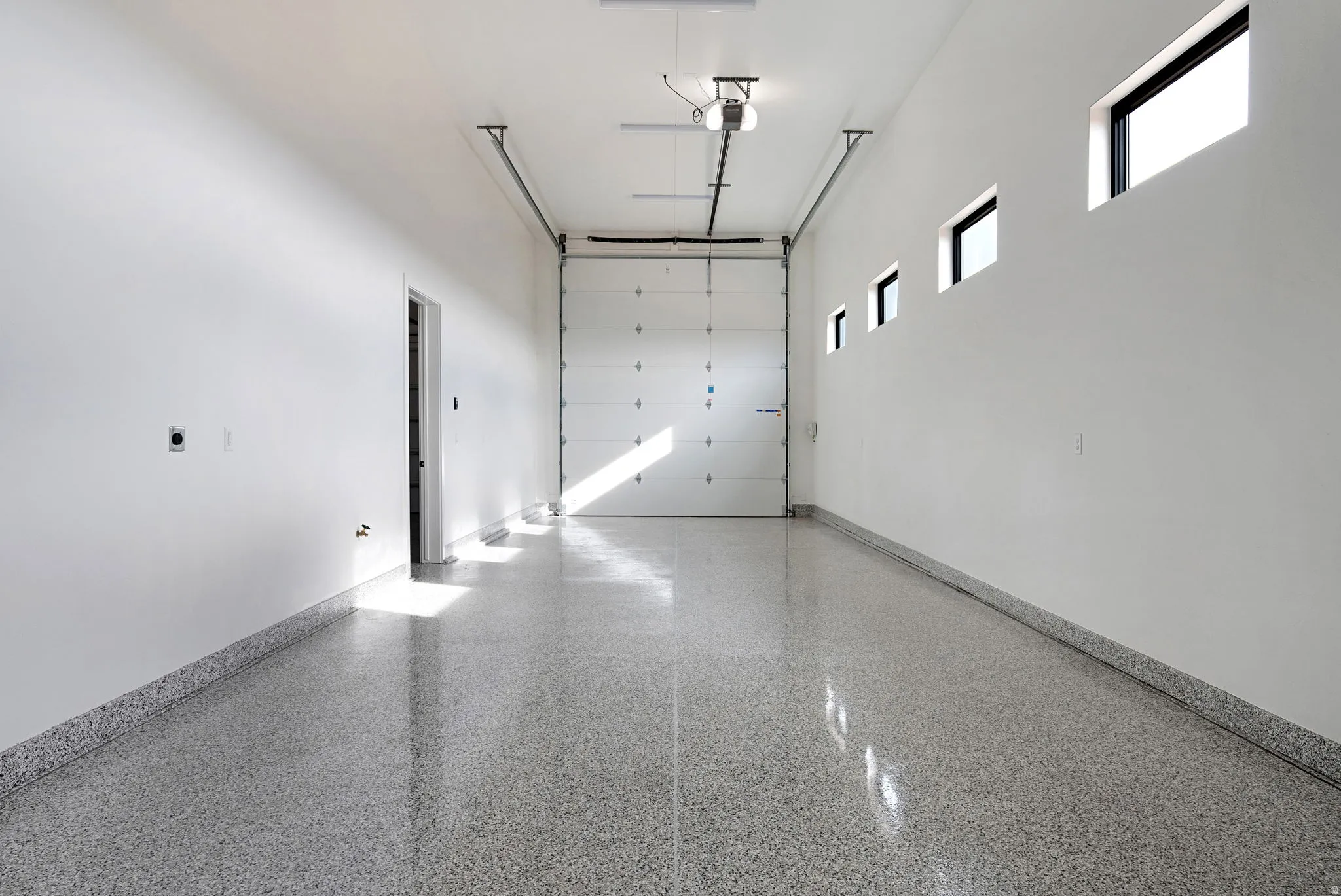 Spacious garage featuring a durable epoxy-coated floor