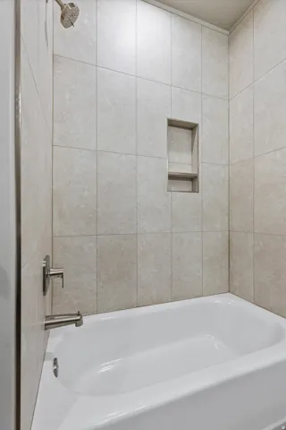 White bathtub with brushed nickel fixtures