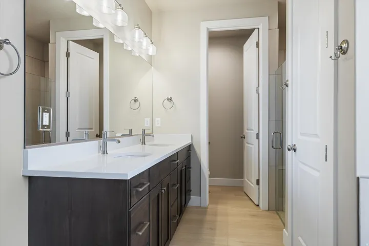 Double vanity featuring a white countertop and dark wood-finish cabinetry