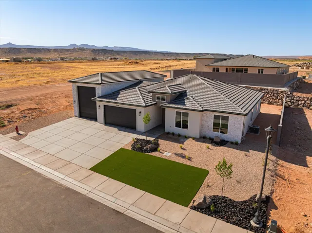 Contemporary single-story residence featuring a light-colored stucco and stone exterior