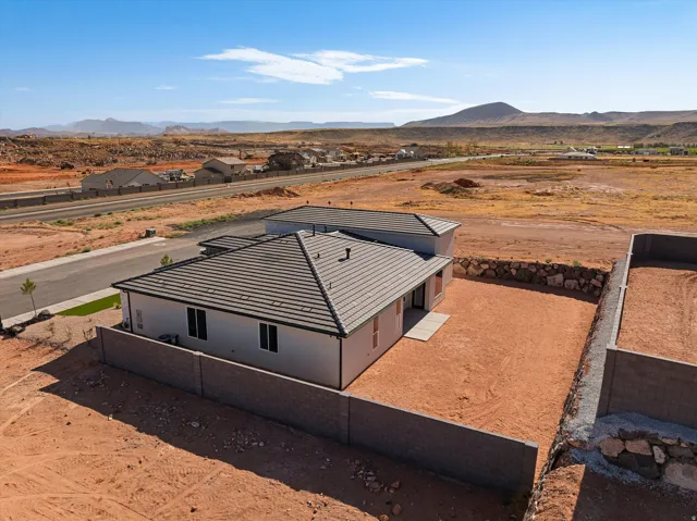 Modern single-story residence featuring a dark tile roof and light-colored stucco exterior
