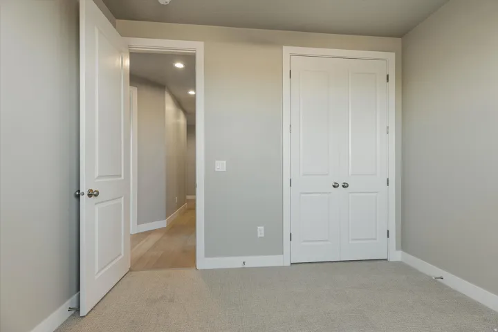 Neutral wall tones with white trim and carpeting