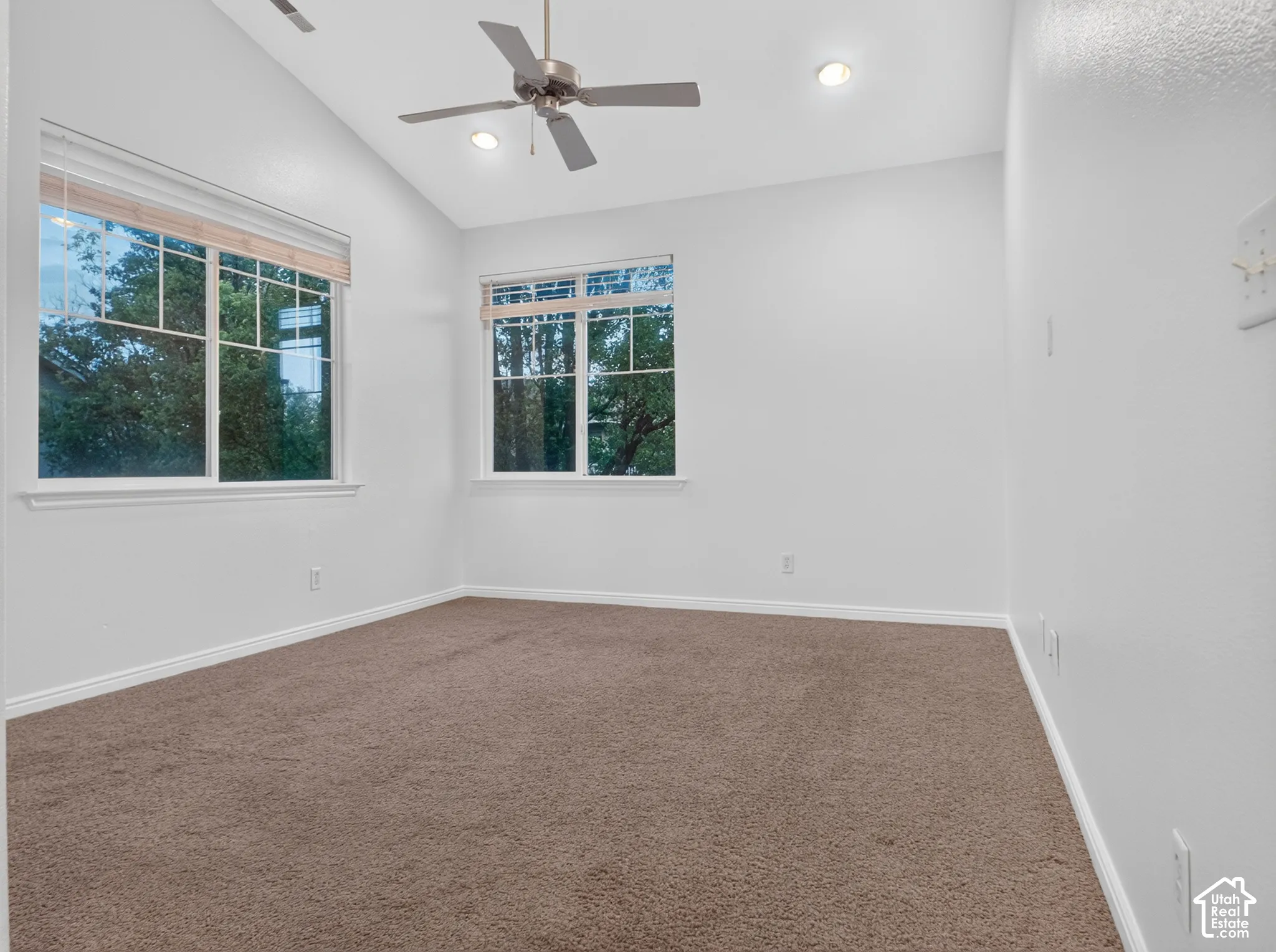 Vaulted ceiling with recessed lighting and ceiling fan