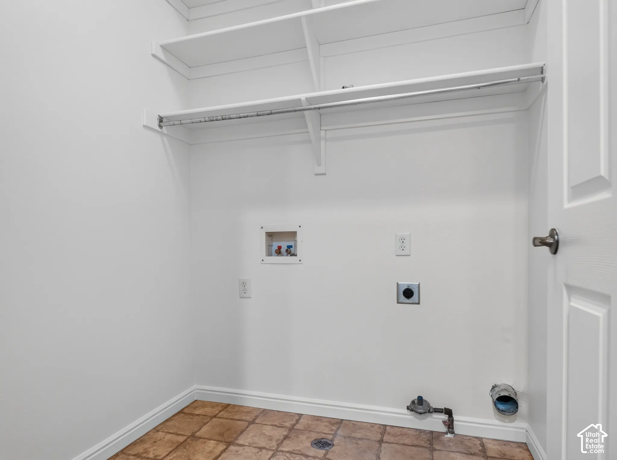 Built-in shelving and hanging rod with tile flooring