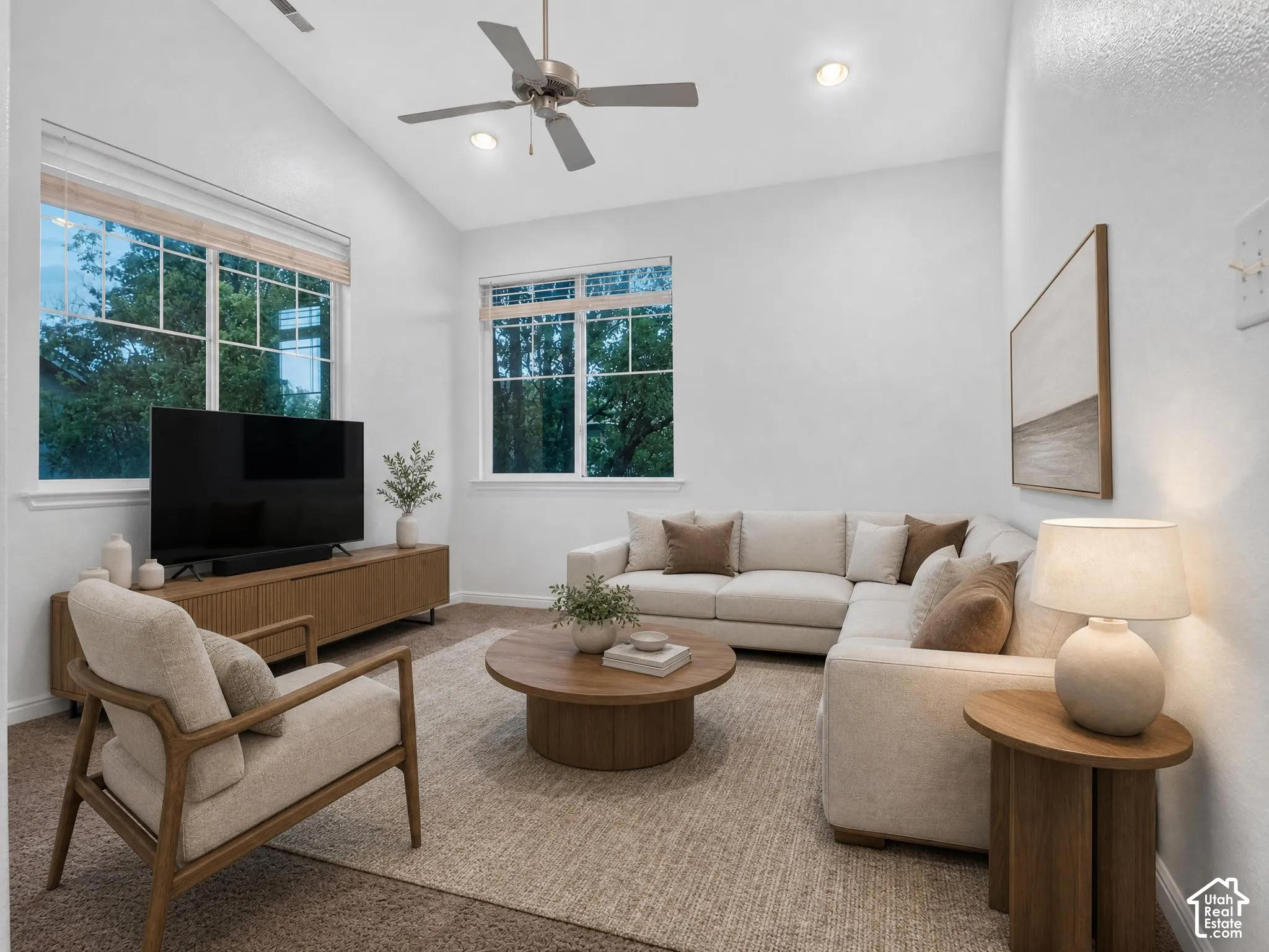 Vaulted ceiling with a ceiling fan, recessed lighting, large windows, and carpeted flooring